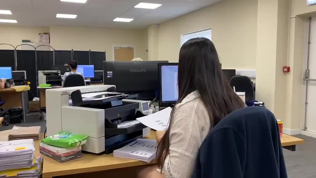 Documents being fed through a production scanner at Stor-a-File