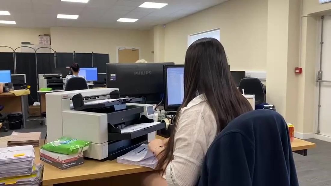 Operator scanning documents on the Stor-a-File production floor