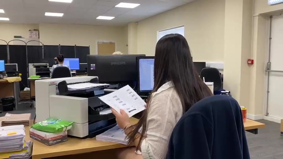 Operator preparing a document at a production scanner on the busy Stor-a-File scanning floor
